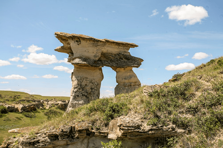 A hoodoo with a blue sky behind it.