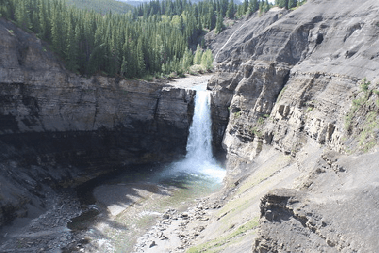 A photo of Rams Falls. You can see the waterfall along a steep cliff face.