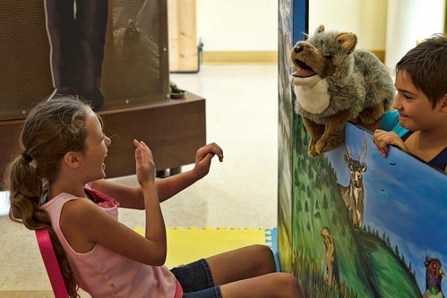 A child laughing at a puppet show.