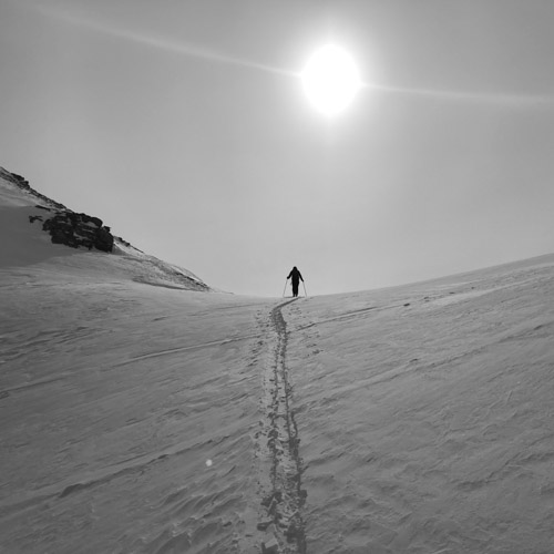 Skier approaching col
